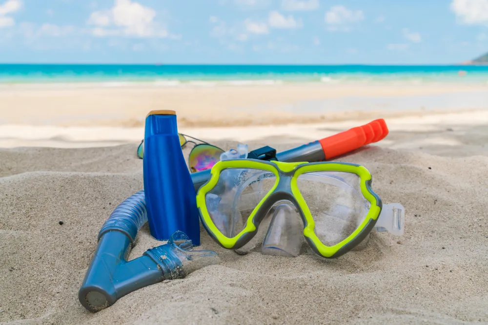 beach accessories including snorkel and water bottle for all inclusive beach vacation