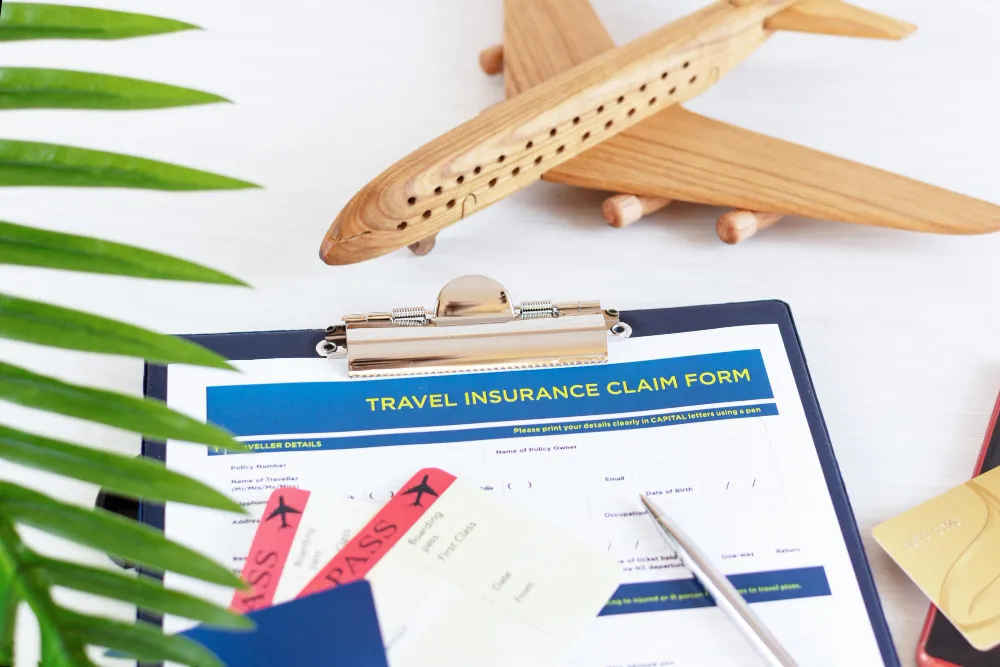 travel-insurance-policy-claim-form-with-boarding-pass-passport-white-wooden-table